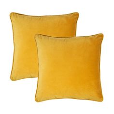 two yellow velvet pillows sitting on top of each other