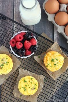 three muffins with berries, raspberries and yogurt on a cooling rack