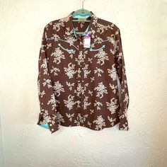 Wrangler 100% Cotton Western Shirt Size Xl. Chocolate With Cream Flowers And Turquoise Satin Trim. Pearl Snap Buttons. New With Tags. Western Brown Tops With Snap Buttons, Western Snap Button Tops, Cow Print Wrangler Shirt, Western Snap Button-up Tops, Western Style Snap Button-up Shirt, Vintage Wrangler, Western Wear For Women, Retro Women, Womens Long Sleeve Shirts