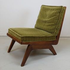 a green chair sitting on top of a white floor