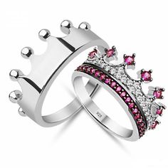 two silver rings with pink and white stones on each ring, one in the shape of a crown