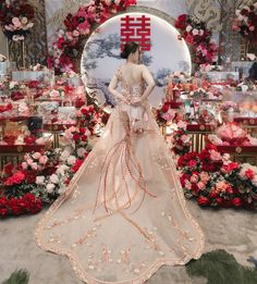 a woman standing in front of a display of flowers