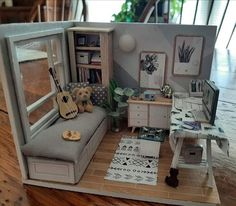 a miniature dollhouse with furniture and accessories in it's living room, as well as a guitar