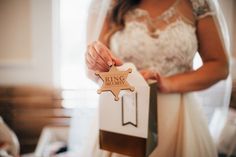 a bride holding a wooden star ornament in her hand