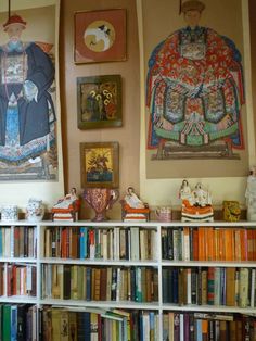 there are many books on the shelves in this room and one is filled with figurines