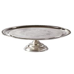 a silver cake plate on a white background