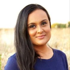 a woman with long black hair and blue shirt