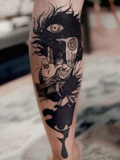 a woman's leg with a tattoo on it and an eye in the background