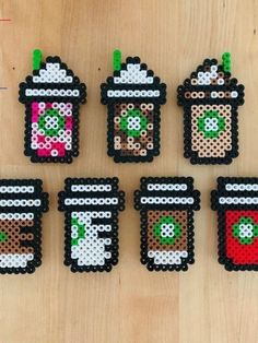 six perler bead coffee cup coasters on a wooden table