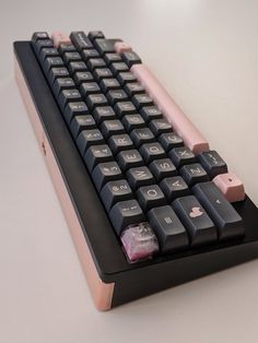 a black keyboard with pink keys on it