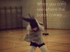 a woman is in the middle of throwing a frisbee on an indoor court