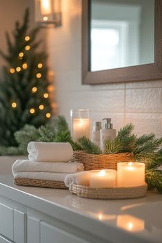 candles and towels are sitting on a mantle in front of a christmas tree with lights