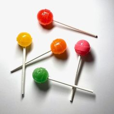 four different colored lollipops sitting on top of each other