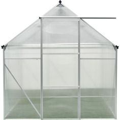 a white greenhouse with the door open and grass growing in it's ground area