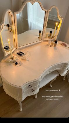 a white dressing table with candles on it