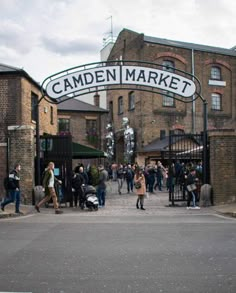 the entrance to camden market in london, england with people walking around and onlookers