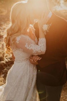 a bride and groom kissing in the sun