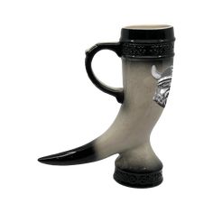 a black and silver coffee mug with horns on it