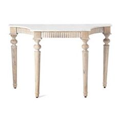 a white marble top table with wooden legs