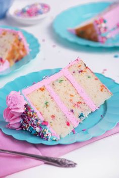 a piece of cake with sprinkles and pink frosting on a blue plate