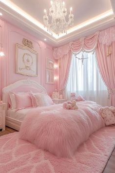 a bedroom decorated in pink and white with chandelier