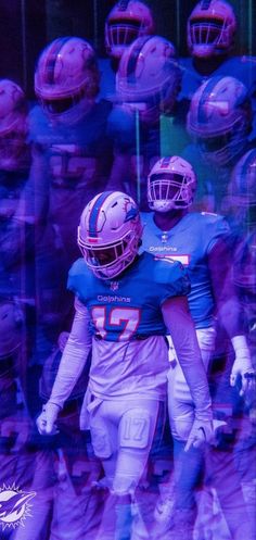 two football players are walking through the tunnel