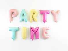 the word party time spelled out with balloons in front of white wall and balloon type letters