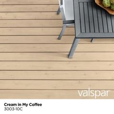 an image of a table and chairs on a wooden deck with coffee beans in a bowl