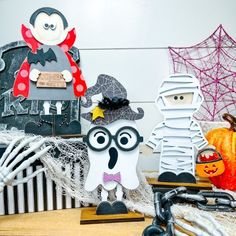 three halloween decorations are sitting on a table