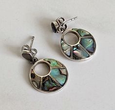 These lovely abalone earrings are perfect for any occasion!  Approximately 1 inch long and 5/8 inch wide.  Marked 925 and do test as sterling silver, with the exception of the stainless steel push backs.  In very good condition--ready to be worn and enjoyed! Note:  Vintage jewelry is jewelry that has been owned and worn previously.  It may have light scratches and/or some tarnish.  I give all my sterling (925) silver pieces a light polish, but leave serious polishing up to the discretion of the Elegant Silver Earrings With Inlay, Silver Inlay Earrings, Silver Inlay Round Earrings, Elegant Silver Inlay Earrings, Handmade Silver Abalone Shell Earrings, Elegant Abalone Shell Pierced Earrings, Vintage Silver Abalone Shell Jewelry, Nickel-free Abalone Shell Drop Earrings, Abalone Earrings