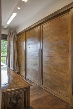 an empty room with wood paneling and sliding doors