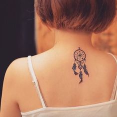 a woman with a tattoo on her back neck