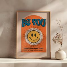 an orange poster with the words be you and a smiley face in front of it