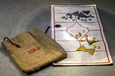 two pieces of cloth sitting on top of a table next to a drawstring bag