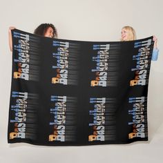 two women holding up a black blanket with the words detroit and their names on it