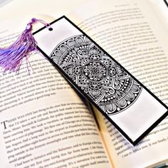 an open book with a tassel on top of it