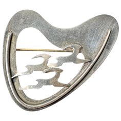 This is a wonderful and rare Denmark Sterling Silver Three Running Deer or Antelope Mid-Century Modernist Brooch. The brooch is fully hallmarked with a maker's mark, Sterling, Denmark and haandarbejde (hand made in Danish). The modernist brooch with open work design and the wonderful running deer or antelope in a geometric form is stunning. The clean lines and elegant curvilinear shapes and nature-inspired motif exemplify the Scandinavian Mid-Century Modernist style. The brooch is 2.5 inches (6. Scandinavian Modernist Jewelry, Geometric Form, Makers Mark, Denmark, Wire Wrapped Jewelry, Lapis Lazuli, Deer, Jewellery And Watches, Diy Jewelry