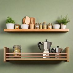 two wooden shelves filled with pots and pans next to each other on top of a green wall