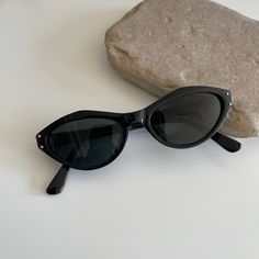 These chic cat-eye frames featuring a black frame with black smoke lens. True genuine vintage sunglasses from the 90s.  - 400 uv  - new vintage from the 90s - includes sunglasses pouch  Measurements: Lens width 50mm Lens height 31mm Frame width 133mm Bridge 14mm Arm temple 140mm Also available in red tortoise https://etsy.me/3oX4usS Nice Glasses, Black Cat Eye, Sunglasses Pouch, Black Cat Eye Sunglasses, Black Cat Eyes, Eye Frames, Oval Sunglasses, Cat Eye Frames, Black Metal Frame