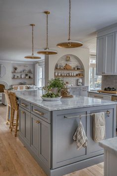 a large kitchen with an island in the middle and lots of counter space around it