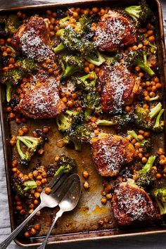 broccoli and chickpeas covered in parmesan cheese on a baking sheet