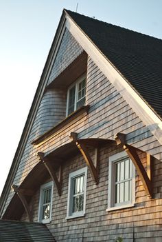 an image of a house that is made out of wood and shingled roofing