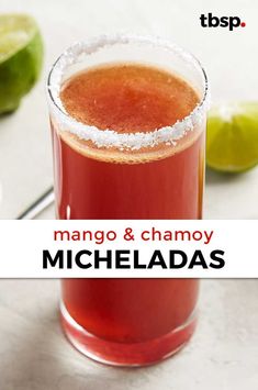 a glass filled with red liquid next to limes on a white counter top and the words mango & chamoy michelada above it