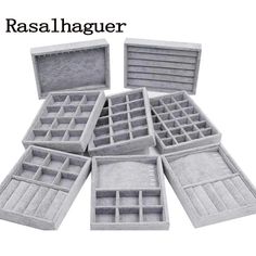 an assortment of grey boxes with compartments for jewelry and other things in them on a white background