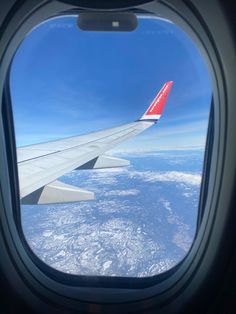 an airplane wing is seen through the window