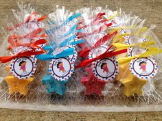 some colorful candies in plastic wrappers on a counter with tags attached to them