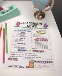 a classroom news paper sitting on top of a desk next to pencils and markers