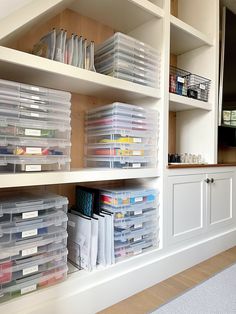 the shelves are filled with plastic containers and files