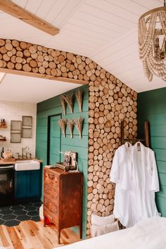 there is a room with wood logs on the wall