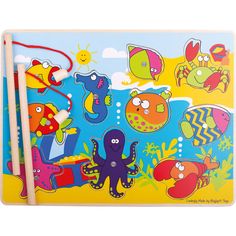 a wooden puzzle with an octopus and other animals on the ocean floor next to two pencils